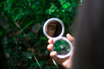 mirror in hand reflecting an eye