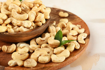 Plates with cashew nuts on table, closeup