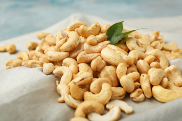 Tasty cashew nuts on table, closeup