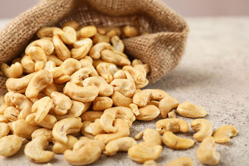 Bag with cashew nuts on table, closeup
