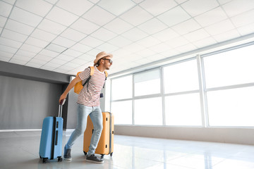 Young man with luggage at the airport