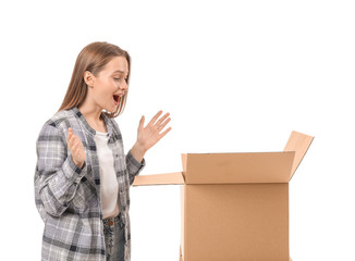 Excited young woman with open moving box on white background