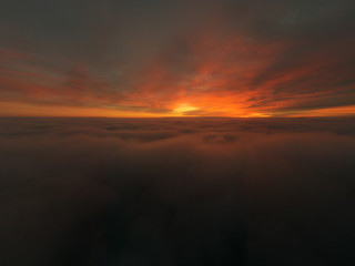 Fototapeta na wymiar Beautiful sunrise cloudy sky from aerial view. Airplane view above clouds
