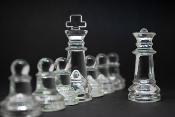 Elite glass chess. Randomly constructed pieces. Close-up on a black background.