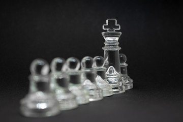 Elite glass chess. Randomly constructed pieces. Close-up on a black background.