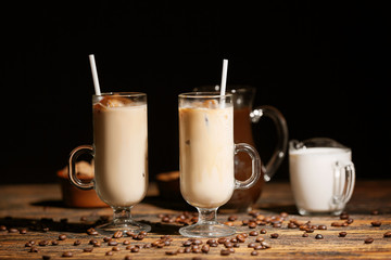 Glass cups of tasty cold coffee on wooden table