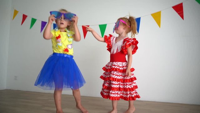 Lovely redhead and blond girls with huge colorful glasses and dresses simper