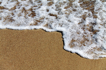 sea ​​wave on the sand. On the sea sand the inscription 