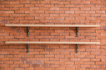 Empty shelves hanging on brick wall