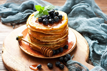 Pancakes with blueberry on ceramic plate