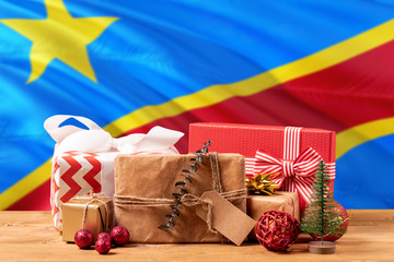 Congo new year celebration theme. Wrapped christmas gifts on waving national flag background. Merry christmas concept.