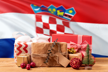 Obraz premium Croatia new year celebration theme. Wrapped christmas gifts on waving national flag background. Merry christmas concept.