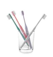 Holder with tooth brushes on white background