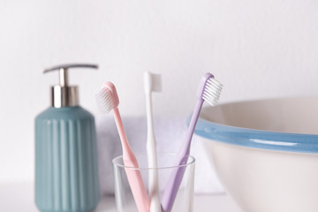 Holder with tooth brushes in bathroom