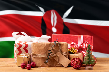 Kenya new year celebration theme. Wrapped christmas gifts on waving national flag background. Merry...