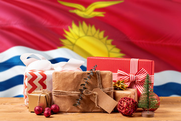 Kiribati new year celebration theme. Wrapped christmas gifts on waving national flag background. Merry christmas concept.