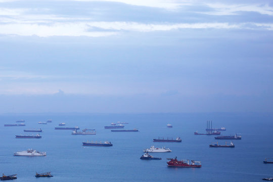 Aerial view of cargo ships in the roadstead. Marine landscape with business or commercial sense.