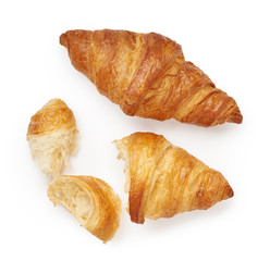 Two croissants with crumbs isolated on white background