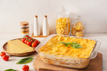 Baking dish with prepared lasagna on white table
