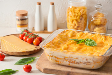 Baking dish with prepared lasagna on white table