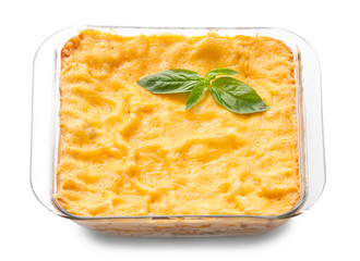 Baking dish with prepared lasagna on white background