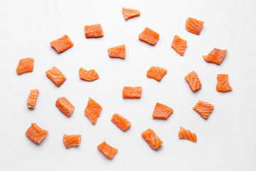 Pieces of fresh raw salmon on white background