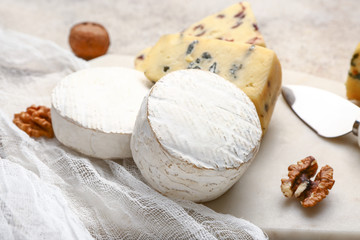 Board with fresh cheese on table