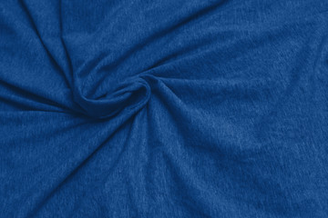 Naklejka na ściany i meble Navy classic blue fabric texture background top view. Crumpled Cloth Blank Background. Colour of the year 2020. Trendy Classic Blue color. Fabric natural surface background. Selective focus.