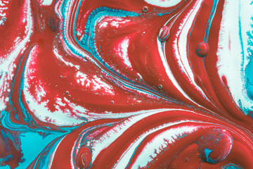 a colourful swirl of oil and red, white and blue water based acrylic and vinyl paints and inks...