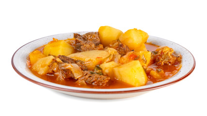 Tasty winter stew with meat and vegetables on a plate. white background