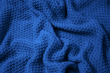Classic blue colour monochrome texture knitted fabric. Blue knitted Jersey as textile background....