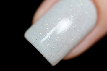 grey manicure with a shimmer on a black background