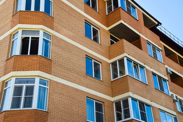 Balconies and windows of a multi-storey new house. New house of