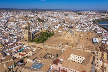 above, drone point of view, aerial view, high up, outdoors, sky, river, spain, road, water, cathedral, tower, old, city, cityscape, europe, ancient, tourism, architecture, andalusia, roman bridge, mos