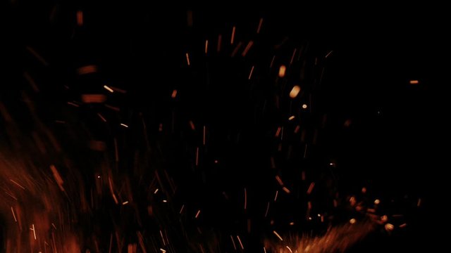 Hot flying embers and sparks in slow motion