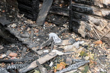 The texture of the destroyed house, charred bricks, rags.