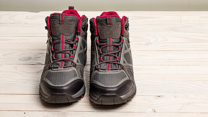 Female hiking boots on white wooden background