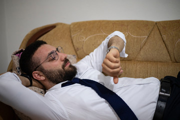 relaxed man checking the hour on his watch