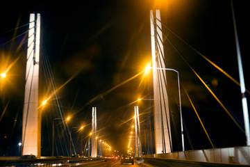 Illuminated road at night on the bridge