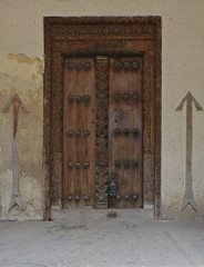 A wooden door, with traditional carvings, in Stonetown, Zanzibar. 