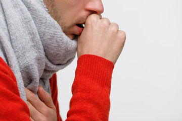 Close up of unhealthy man in orange sweater suffering with pulmonary cough due to cold, flu,...