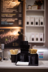 Disposable coffee cups for making coffee or tea. On a blurry coffee cafe.