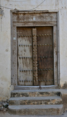 A wooden door, with traditional carvings, in Stonetown, Zanzibar. 