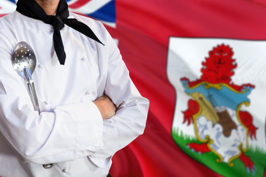 Bermuda Domestic Food Concept. Professional Chef In White Uniform Is Standing With Metal Spatula. Copy Space For Text.