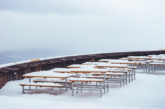 Snow-covered tables of a cafe on the top of mountain Pilatus