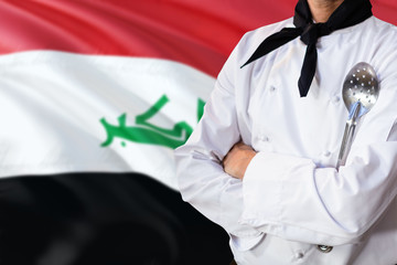 Iraq domestic food concept. Professional chef in white uniform is standing with metal spatula. Copy...