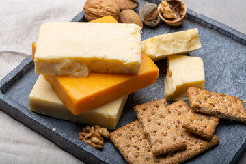 Cheese collection, matured and orange original British cheddar cheese in blocks served with crackers
