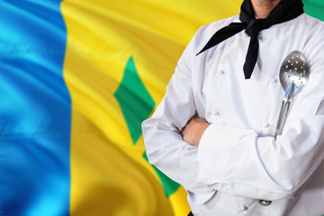 Saint Vincent And The Grenadines domestic food concept. Professional chef in white uniform is...