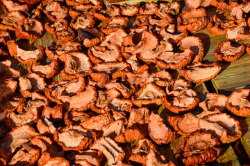 Dried fruits are dried on a wooden board. Dried apples, cut into