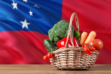 Samoa organic food concept. National flag background with basket full of vegetables on wooden...